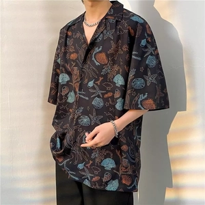 Detail of Hawaiian short sleeve shirt with vibrant starfish and shell ocean patterns