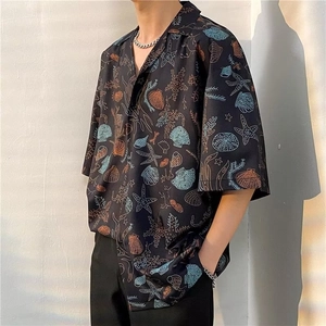 Close-up of Hawaiian floral shirt with starfish and shell patterns on black fabric