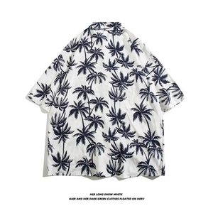 Back view of loose Hawaiian shirt with tropical navy palm tree print on white fabric