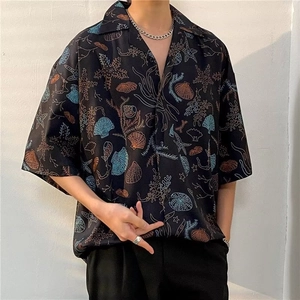 Close-up of Cuban collar and marine life pattern on black Hawaiian beach shirt