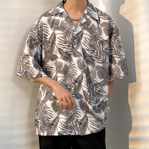 Detail of oversized summer shirt featuring vintage leaf print and draped texture