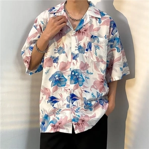Detail of floral short-sleeve shirt featuring chest pocket and tropical print patterns