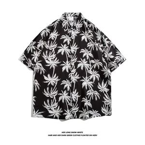 Detail of the palm tree print and button-down collar on this short sleeve beach shirt