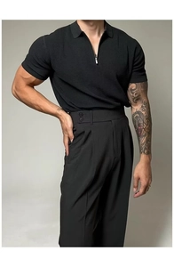 Detail of slim fit black knit polo shirt with zip collar and high waist trousers