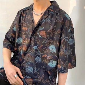 Close-up of Hawaiian short sleeve shirt featuring detailed starfish and coral ocean prints