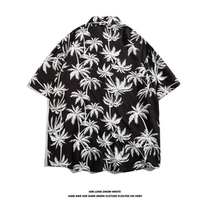 Detail view of tropical coconut tree print on back of men's short-sleeved beach shirt
