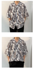 Detail of oversized Cuban collar shirt featuring tropical black and white leaf prints