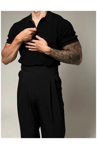 Detail of black knit polo shirt featuring vertical texture and quarter zip collar