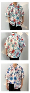 Detail view of the breathable fabric and tropical floral pattern on a loose Hawaiian shirt