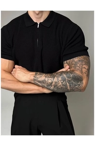 Detail of black slim fit knit polo shirt with zipper collar and fine vertical texture