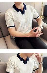 Detail of white men's knit polo shirt featuring navy herringbone texture and V-neck