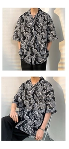 Detail of oversized Hawaiian shirt with white palm leaf prints and relaxed drop shoulders