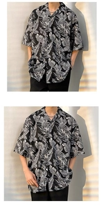 Detail of tropical palm leaf print shirt with Cuban collar and button-down front