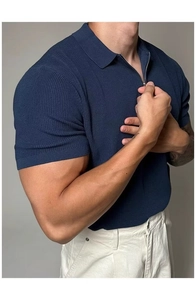 Detail of dark blue knit polo shirt with quarter-zip collar and vertical texture