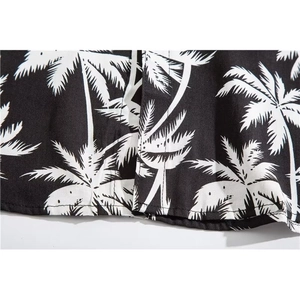 Close-up of Hawaiian short sleeve shirt with palm tree print and neat hem stitching