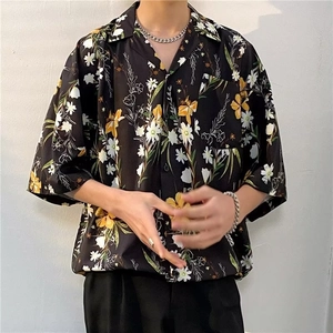 Detail of tropical floral print on a relaxed fit Hawaiian shirt with front pocket