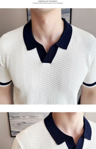 Close-up of white knit polo shirt featuring navy contrast collar and herringbone texture