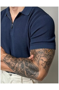 Close-up of navy blue knit polo shirt featuring a zipper collar and ribbed texture