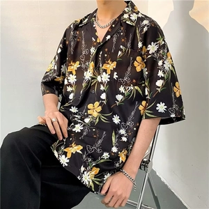 Close-up of tropical floral print and functional chest pocket on men's short sleeve shirt