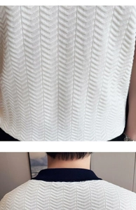 Detailed macro view of cream herringbone knit fabric and navy ribbed polo collar design