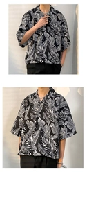 Macro detail of summer oversized shirt featuring tropical leaf print and flowy fabric texture