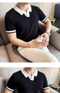 Detailed close-up of men's black knit Polo shirt with V-neck and white contrast trim