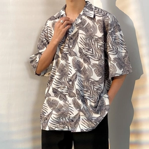 Oversized Hawaiian short sleeve shirt with tropical leaf pattern and relaxed Cuban collar