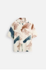 Close-up of abstract oil painting print and classic cuban collar on casual shirt