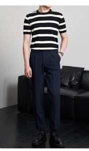 Detail der schwarz-weiß gestreiften Strickoberteil und schmalen dunkelblauen Hose