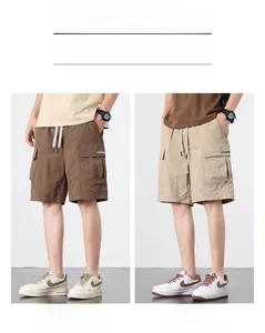 Detail of cargo shorts showing elastic drawstring waist and large pockets in caramel and khaki