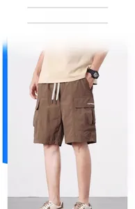 Detail view of caramel cargo shorts with elastic drawstring waist and side pockets