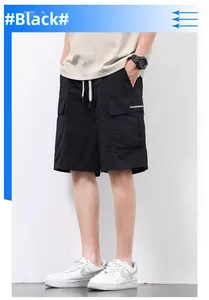 Detail of black cargo shorts featuring elastic waistband with white drawstrings and side pockets
