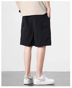 Detail of black cargo shorts featuring functional flap pockets and quick-dry fabric