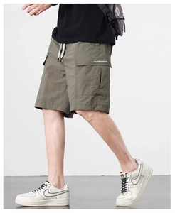 Detail of army green ice silk cargo shorts featuring elastic waist and utility pockets