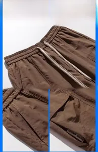 Detail of brown quick-dry cargo shorts featuring drawstring waist and large side pockets