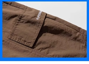 Detail of dark brown cargo shorts showing textured fabric and FUFENGS embroidery