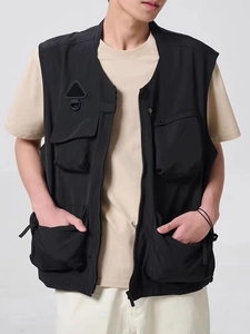 Detail view of the multi-pocket utility vest showing heavy-duty zipper and functional pockets