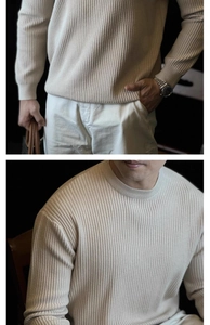 Detail of beige ribbed knit sweater showing the vertical texture and crew neck design