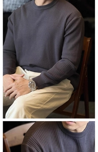 Close-up of charcoal grey vertical ribbed knit fabric on men's crewneck sweater
