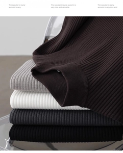 Detail of ribbed knit sweaters in coffee, grey, white, charcoal, and black colors