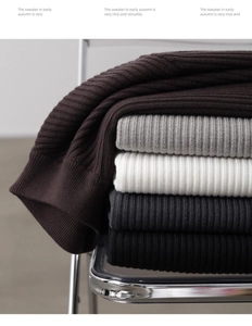 Detailed view of vertically ribbed knit fabric in dark brown, grey, and cream textures