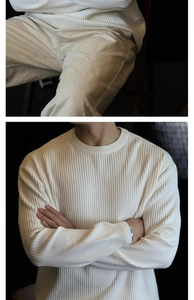 Close-up of white vertical ribbed knit sweater fabric and crewneck long sleeve texture