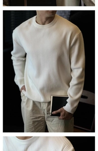 Close-up of white ribbed knit texture on a men's vintage crewneck sweater for autumn