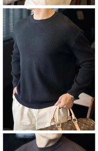 Detail view of vertical striped knit texture on a men's casual crewneck sweater