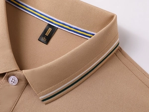 Macro detail of brown piqué Polo collar with elegant green and white jacquard stripes