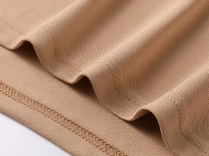 Macro view of khaki pique cotton polo shirt fabric showing breathable mesh and double stitching