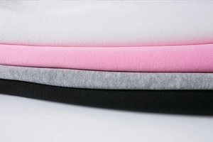 Detail showing layers of soft knit fabric in white, pink, grey and black colors