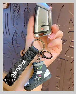 Detailed view of high-top graffiti sneaker keychain with rabbit motif and black wrist strap
