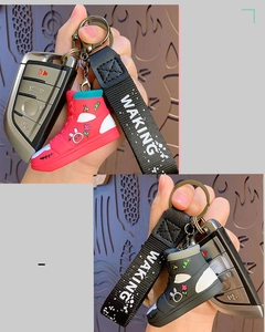 Detail of creative sneaker keychain with cartoon rabbit patterns and fabric hand strap