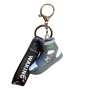 Graffiti high-top sneaker keychain with cartoon rabbit pattern and black branded wrist strap
